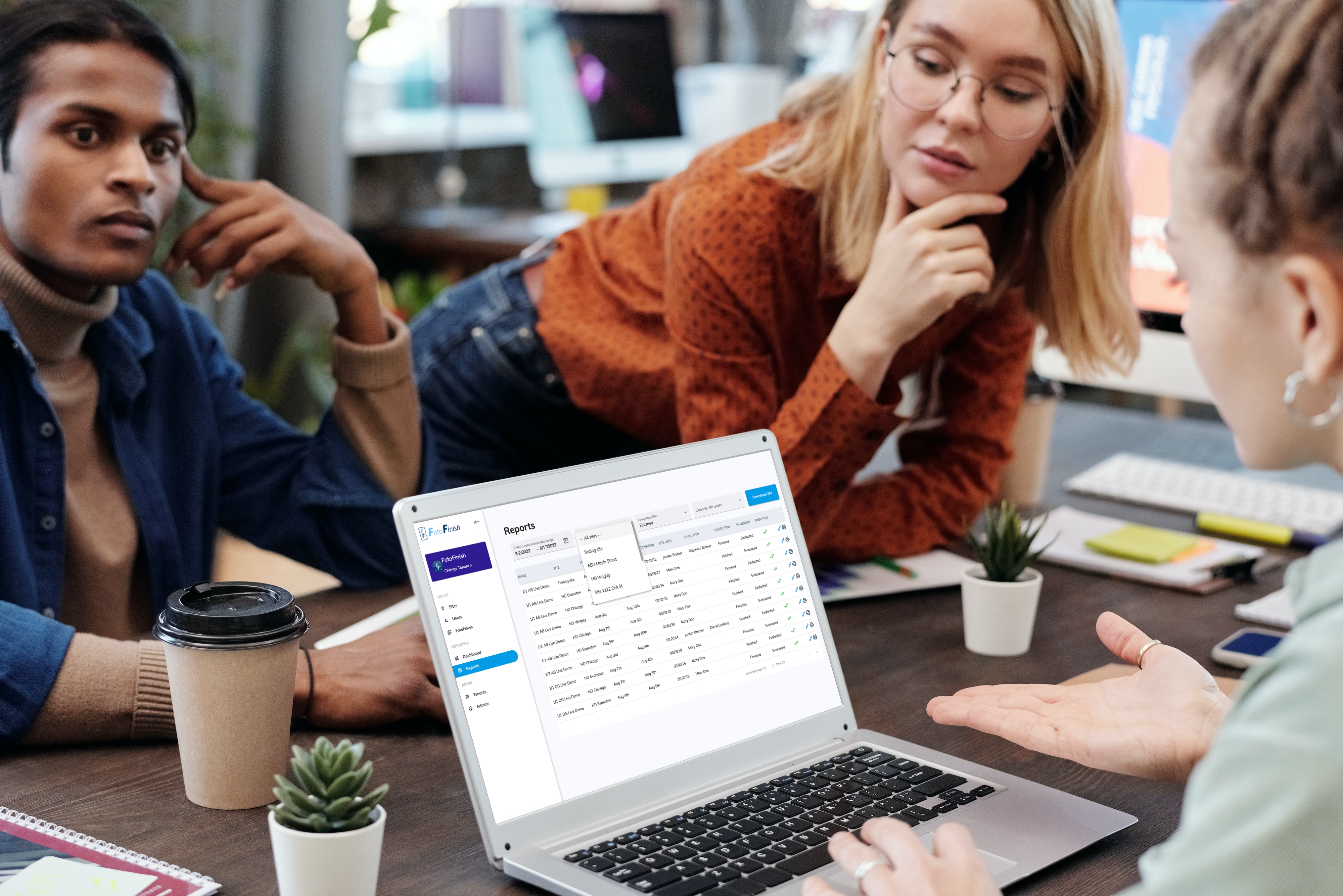 Team reviewing FotoFinish photo report history on a laptop